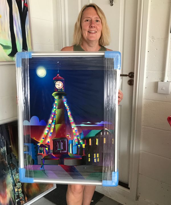 Jayne Edwards of Tredegar collects her painting 'Tredegar Clocktower Moonlight'.